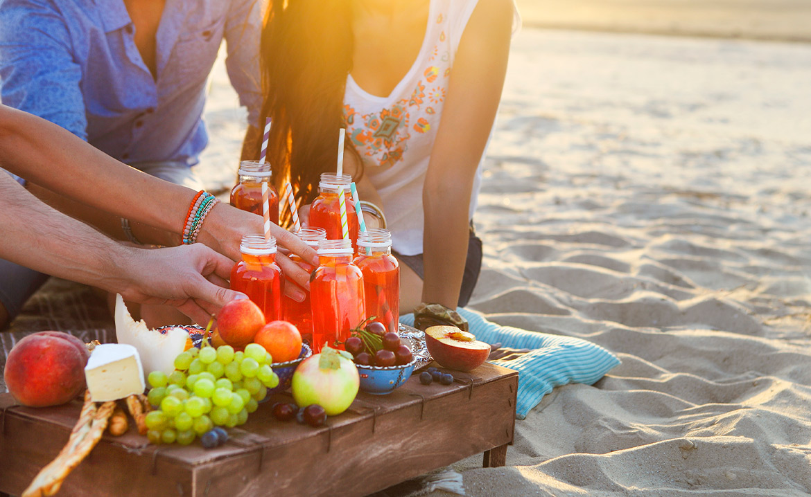 couple sharing fruit and cocktails at breach