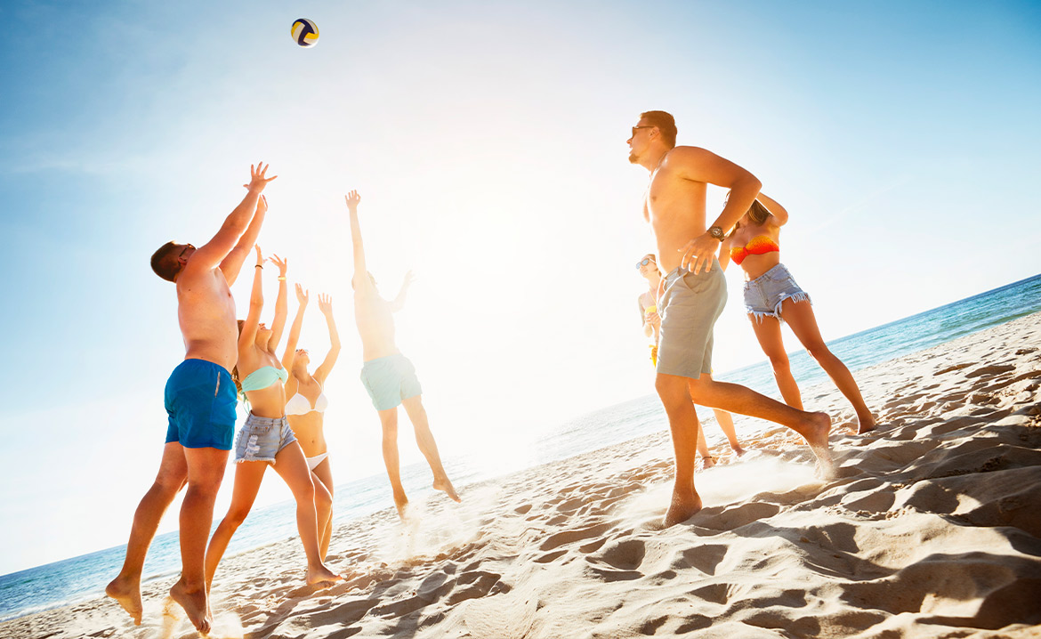 people playing volleyball at beach