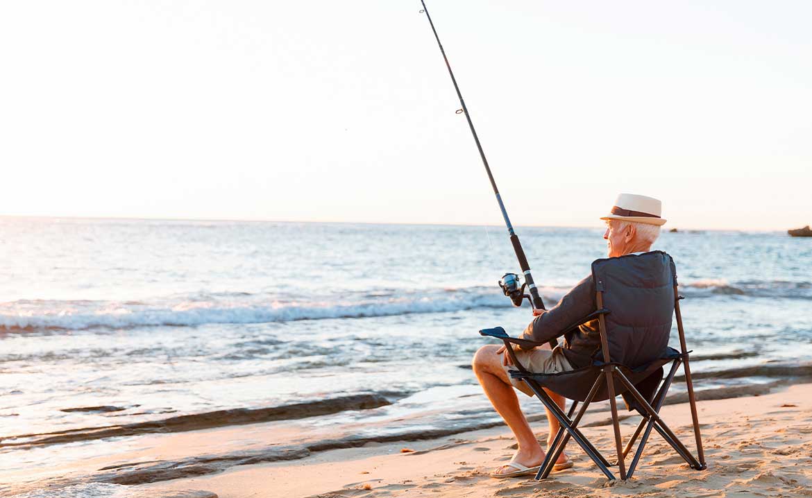 Man seating and fishing on the shoreline 
