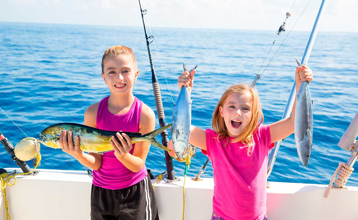 two kids with fish prize. Fishing with family in South Padre