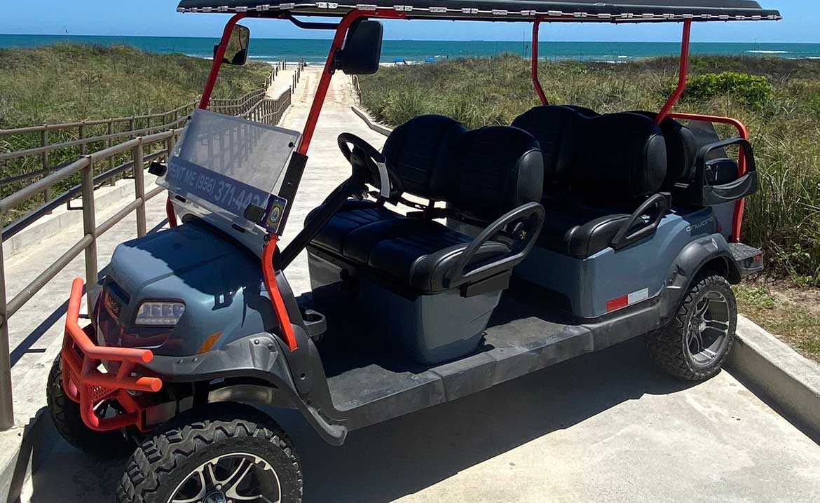 A beach-ready golf cart with four seats, enjoying the sunny weather at South Padre Island.