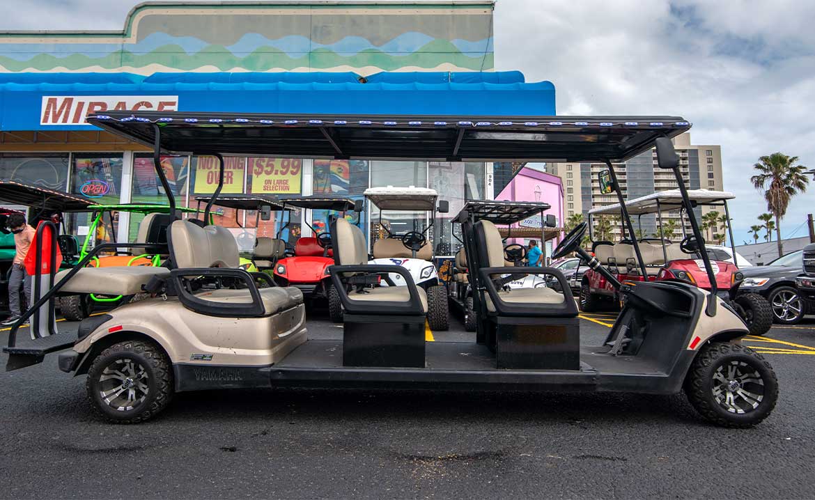 golf cart for 8 persons. A four-seat golf cart with a canopy, ideal for group activities and transportation on South Padre Island.