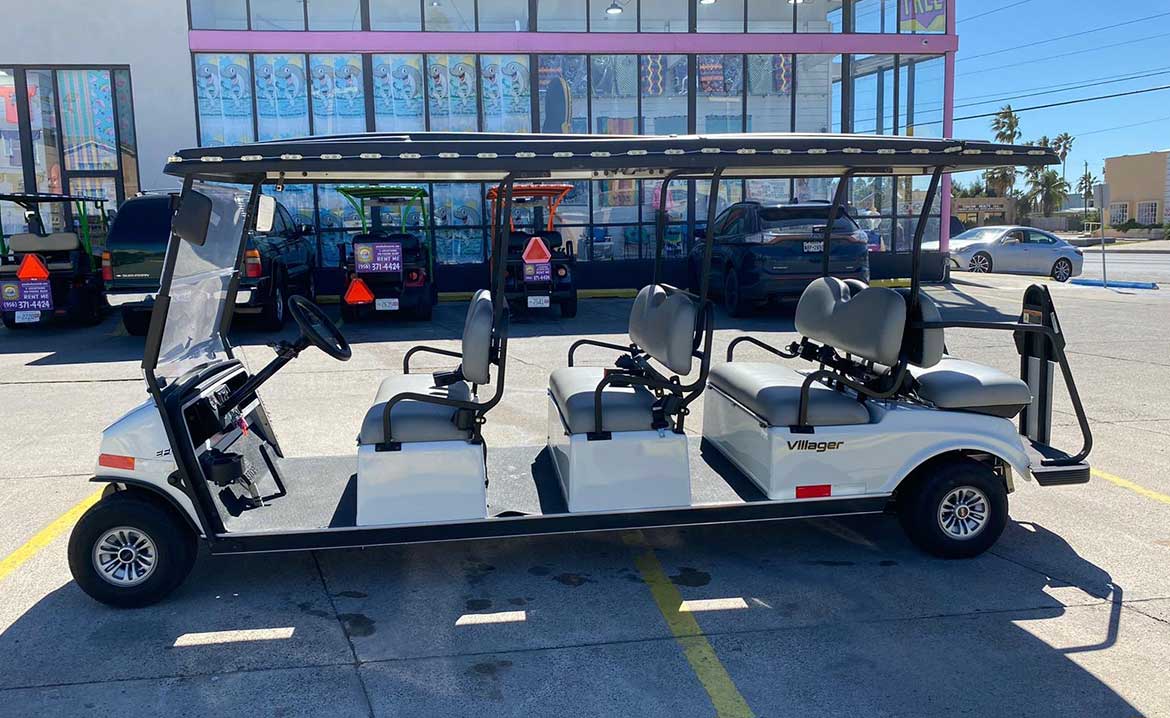 A white 8 seater golf cart featuring four seats and a roof, displayed in the context of South Padre Island's traffic regulations.