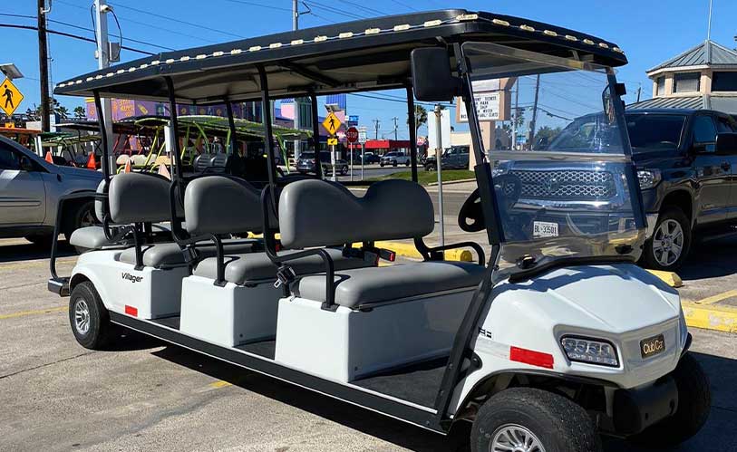 A white golf cart with black seats and a black roof, suitable for exploring SPI during your trip.