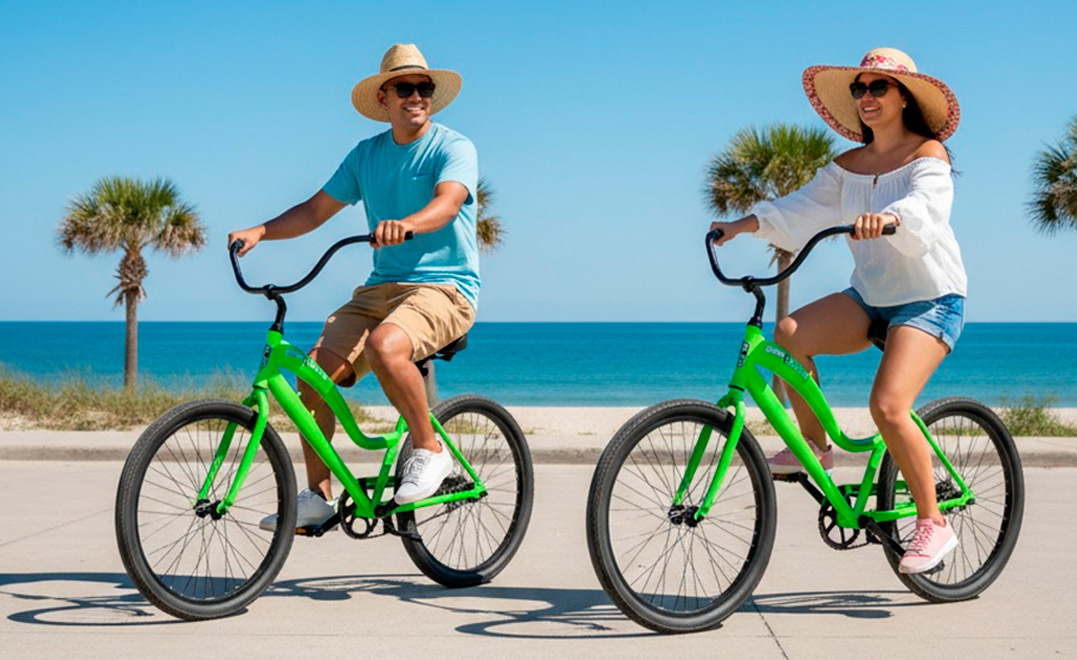 Two cyclists pedaling on the beach, showcasing the bike rental experience at South Padre Island.